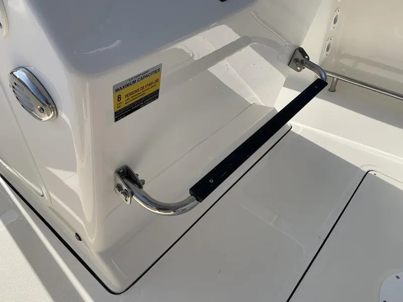 Slide: The Image of 2025 Pioneer ISLANDER 202 boat interior with safety handle and capacity label. - 23