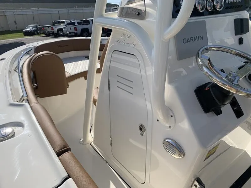 Slide: The Image of 2025 Pioneer ISLANDER 202 boat interior with Garmin system and brown seating. - 25