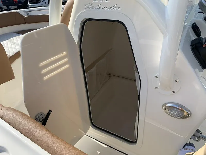 Slide: The Image of 2025 Pioneer ISLANDER 202 boat interior with open storage compartment. - 26