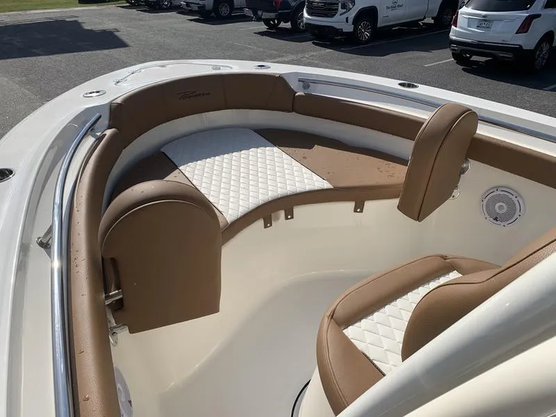 Slide: The Image of 2025 Pioneer ISLANDER 202 boat interior with tan and white seating, parked in a lot. - 27
