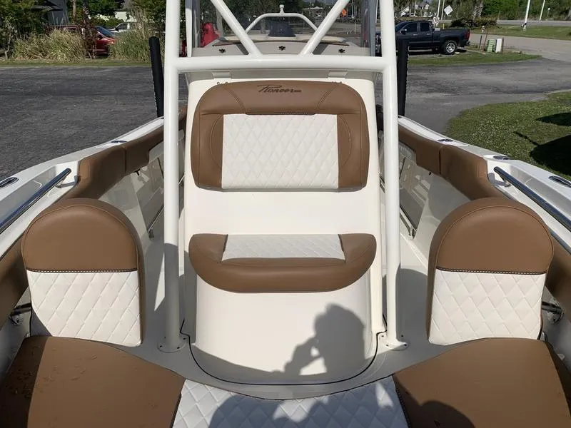 Slide: The Image of 2025 Pioneer ISLANDER 202 boat interior with tan and white seating. - 29