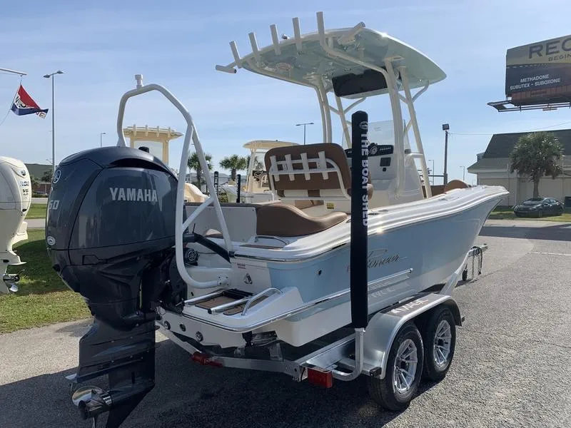 Slide: The Image of 2025 Pioneer ISLANDER 202 boat with Yamaha engine on a trailer, parked outdoors. - 4
