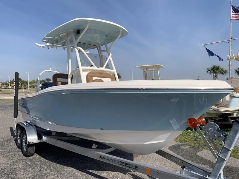 Slide: The Image of 2025 Pioneer ISLANDER 202 boat on trailer, sleek design, light blue hull, sunny day. - 7