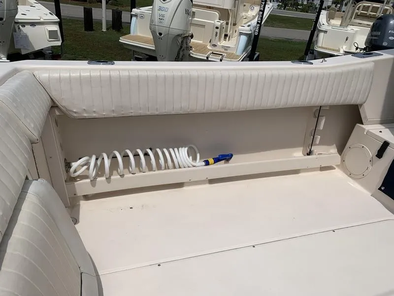 Slide: The Image of 2006 Grady-White 258 Journey boat interior with coiled hose and seating. - 12