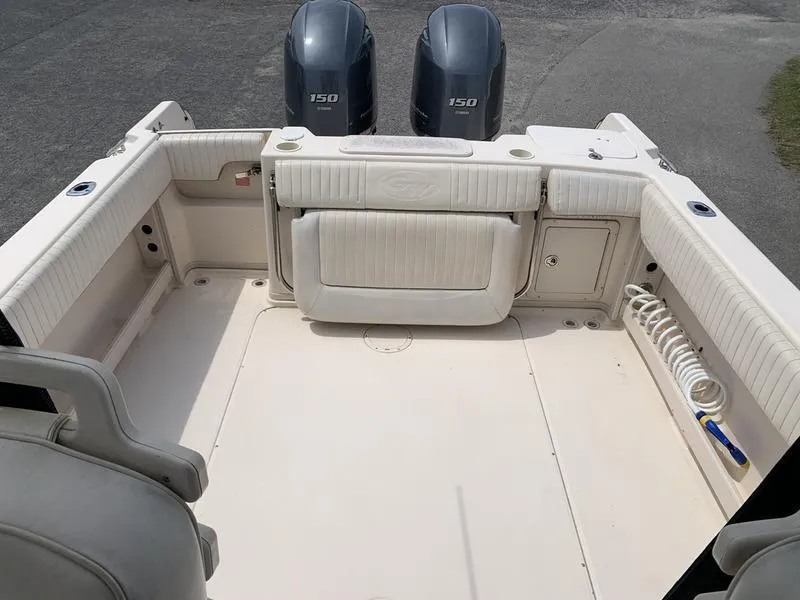 Slide: The Image of 2006 Grady-White 258 Journey boat deck with twin 150 engines, spacious seating, and storage. - 16