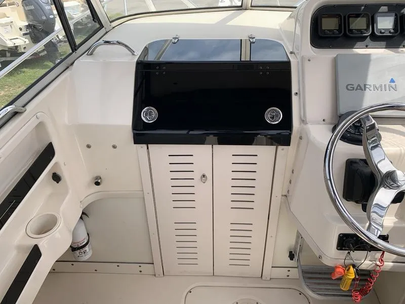 Slide: The Image of 2006 Grady-White 258 Journey boat helm with Garmin navigation system and steering wheel. - 18