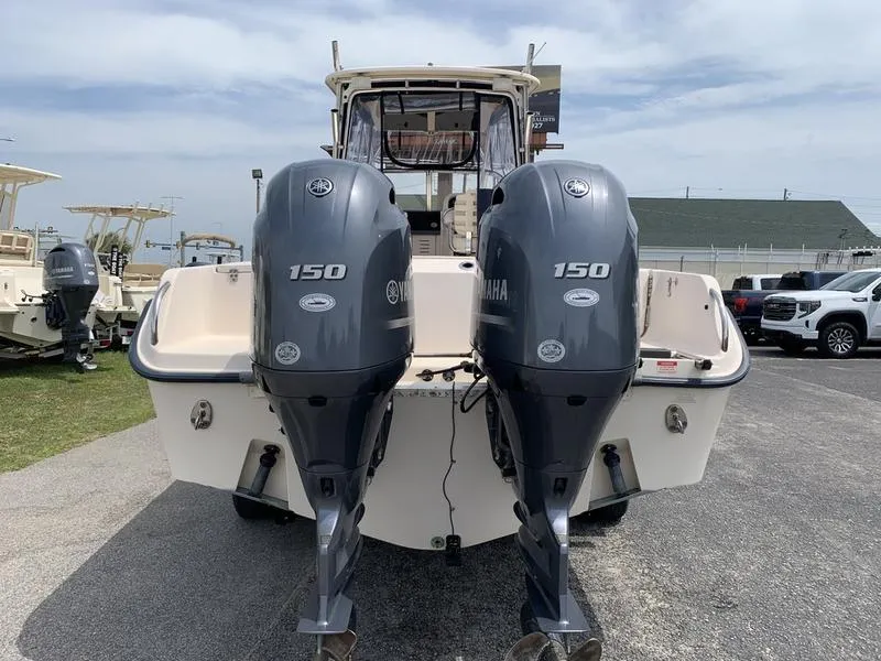 Slide: The Image of 2006 Grady-White 258 Journey boat with twin Yamaha 150 engines, docked outdoors. - 2