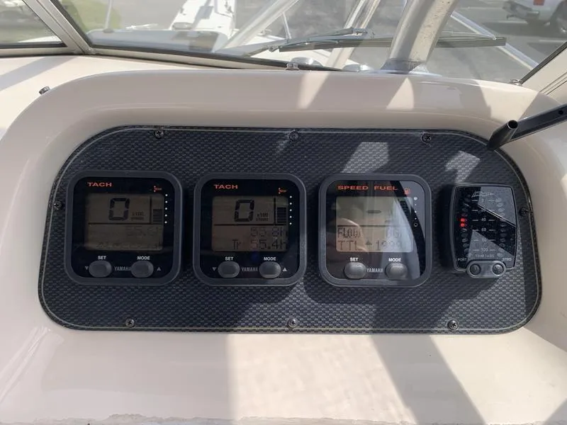 Slide: The Image of Dashboard of 2006 Grady-White 258 Journey boat with tachometer and speed fuel gauges. - 21