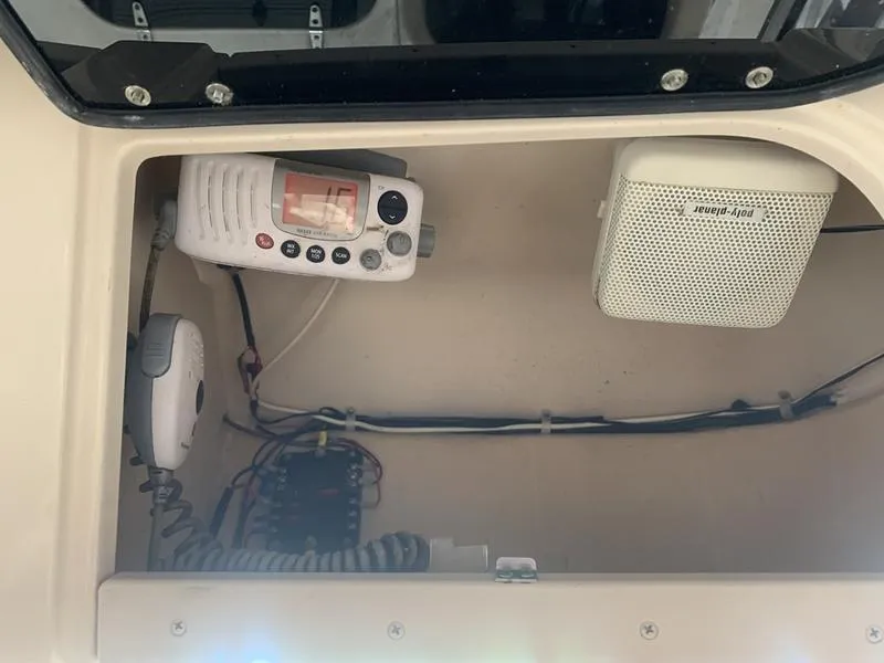 Slide: The Image of 2006 Grady-White 258 Journey boat electronics compartment with radio and speaker. - 23
