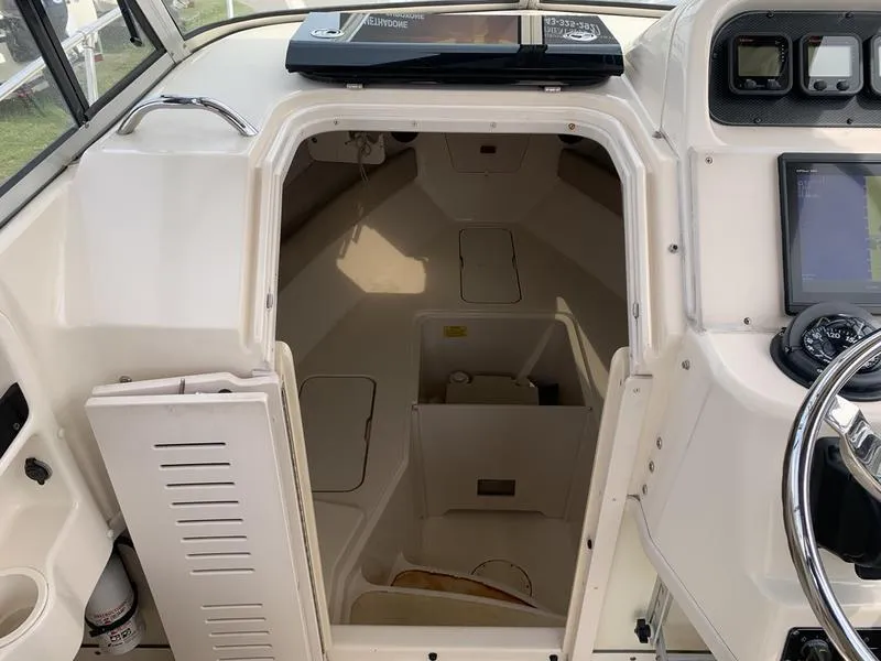 Slide: The Image of 2006 Grady-White 258 Journey boat cabin interior with helm and seating area. - 24