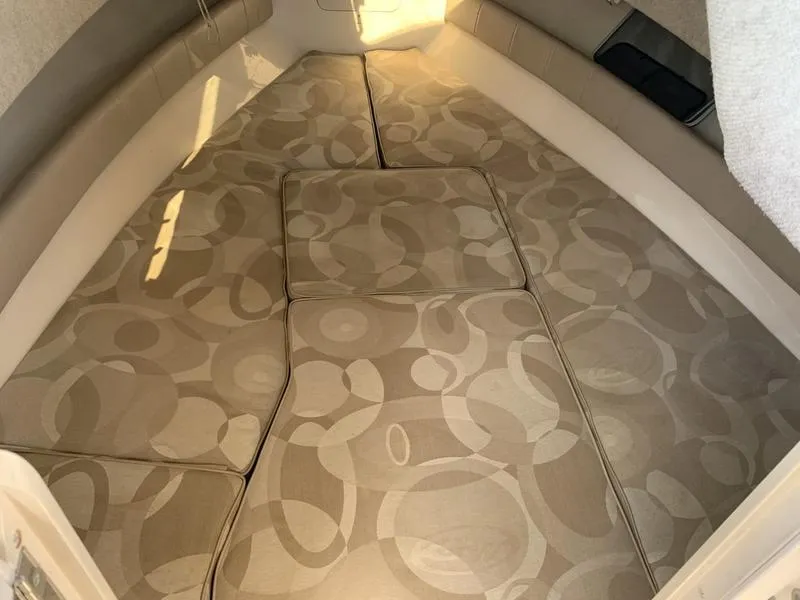 Slide: The Image of 2006 Grady-White 258 Journey cabin interior with patterned cushions. - 25