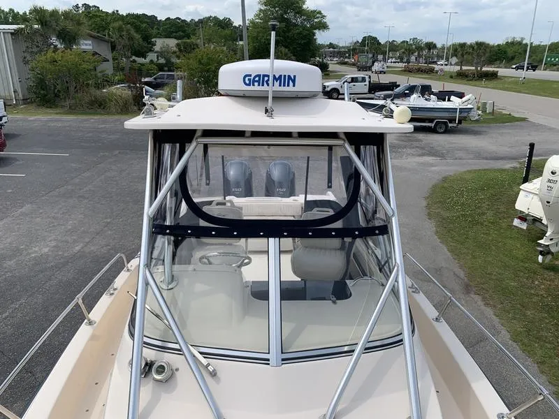 Slide: The Image of 2006 Grady-White 258 Journey boat with Garmin radar, parked outdoors. - 30