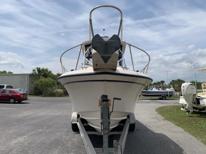Slide: The Image of 2006 Grady-White 258 Journey boat on trailer, parked outdoors under cloudy sky. - 6