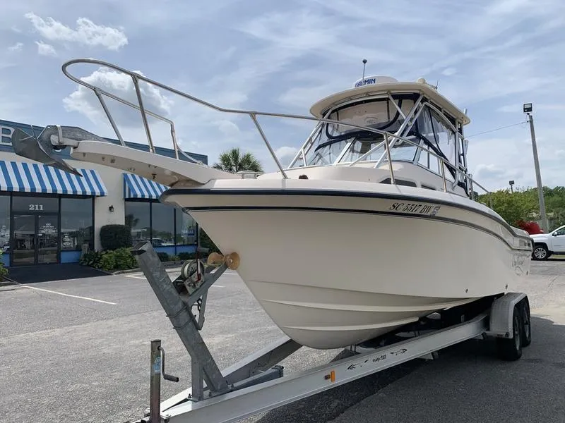 Slide: The Image of 2006 Grady-White 258 Journey boat on trailer in parking lot. - 7