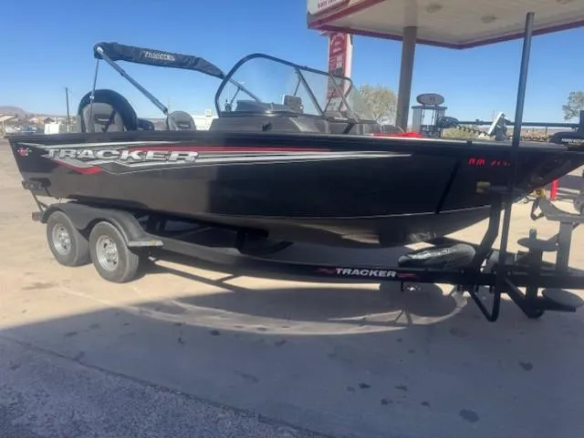 Slide: The Image of 2024 Tracker Targa V18 boat on trailer at a gas station. - 4