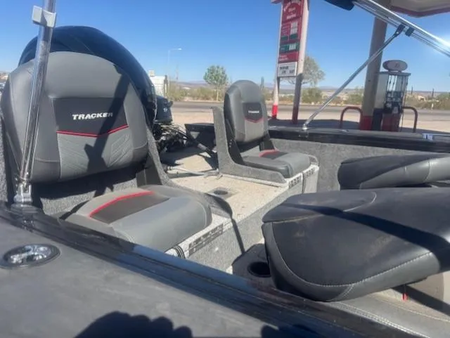 Slide: The Image of 2024 Tracker Targa V18 boat interior with cushioned seats at a gas station. - 5