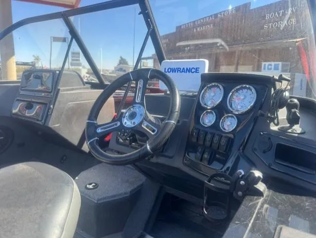 Slide: The Image of 2024 Tracker Targa V18 boat dashboard with steering wheel and gauges. - 6