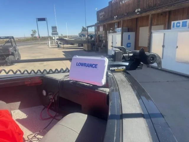 Slide: The Image of 2024 Tracker Targa V18 boat with Lowrance and Minn Kota equipment at a dockside location. - 7