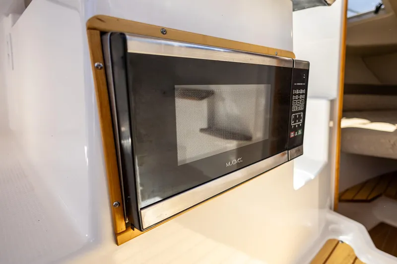 Slide: The Image of Built-in microwave in 2019 Cutwater C-24 Coupe boat interior. - 11
