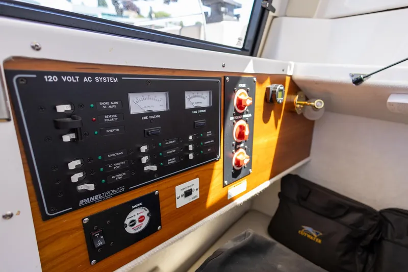 Slide: The Image of Control panel of a 2019 Cutwater C-24 Coupe boat, featuring 120-volt AC system. - 14