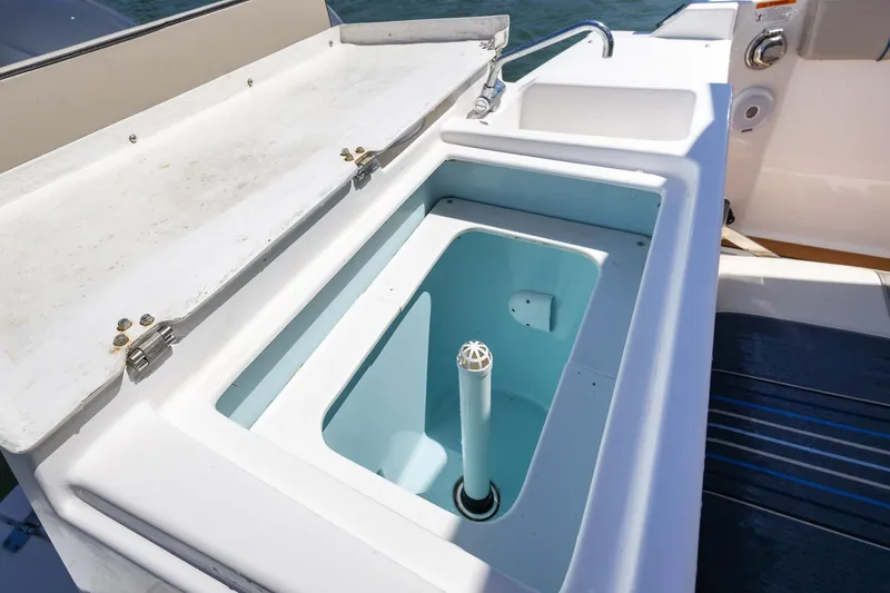 Slide: The Image of 2019 Cutwater C-24 Coupe boat sink and storage compartment on deck. - 15