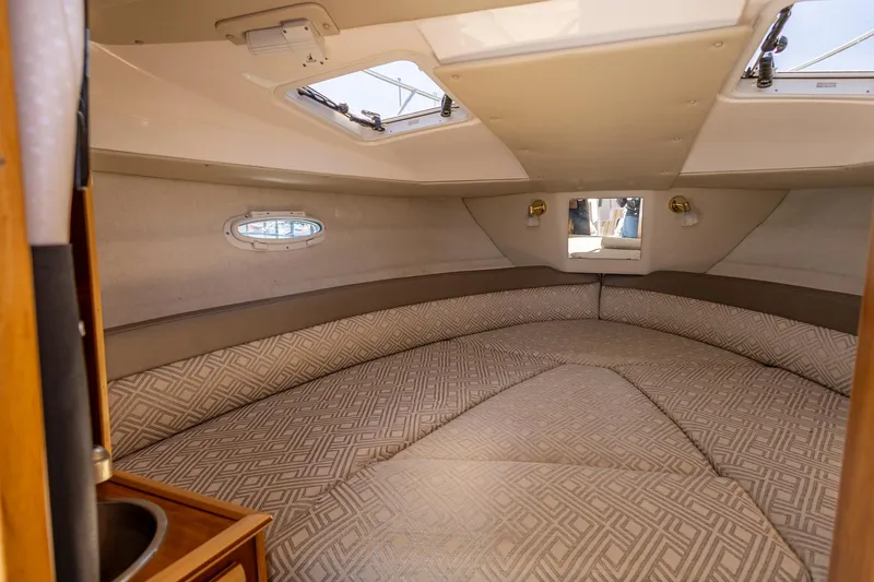 Slide: The Image of 2019 Cutwater C-24 Coupe interior cabin with patterned seating and skylights. - 8