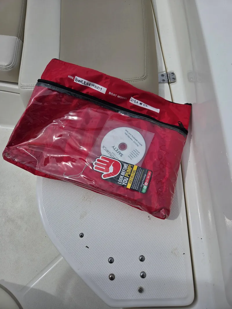 Slide: The Image of Red safety kit on a 2019 Boston Whaler 240 Dauntless boat seat. - 19