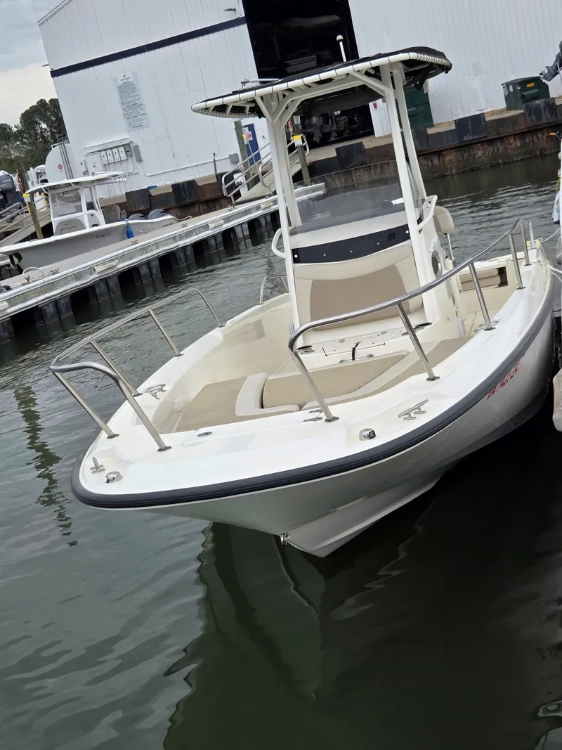 Slide: The Image of 2019 Boston Whaler 240 Dauntless boat docked at marina. - 2