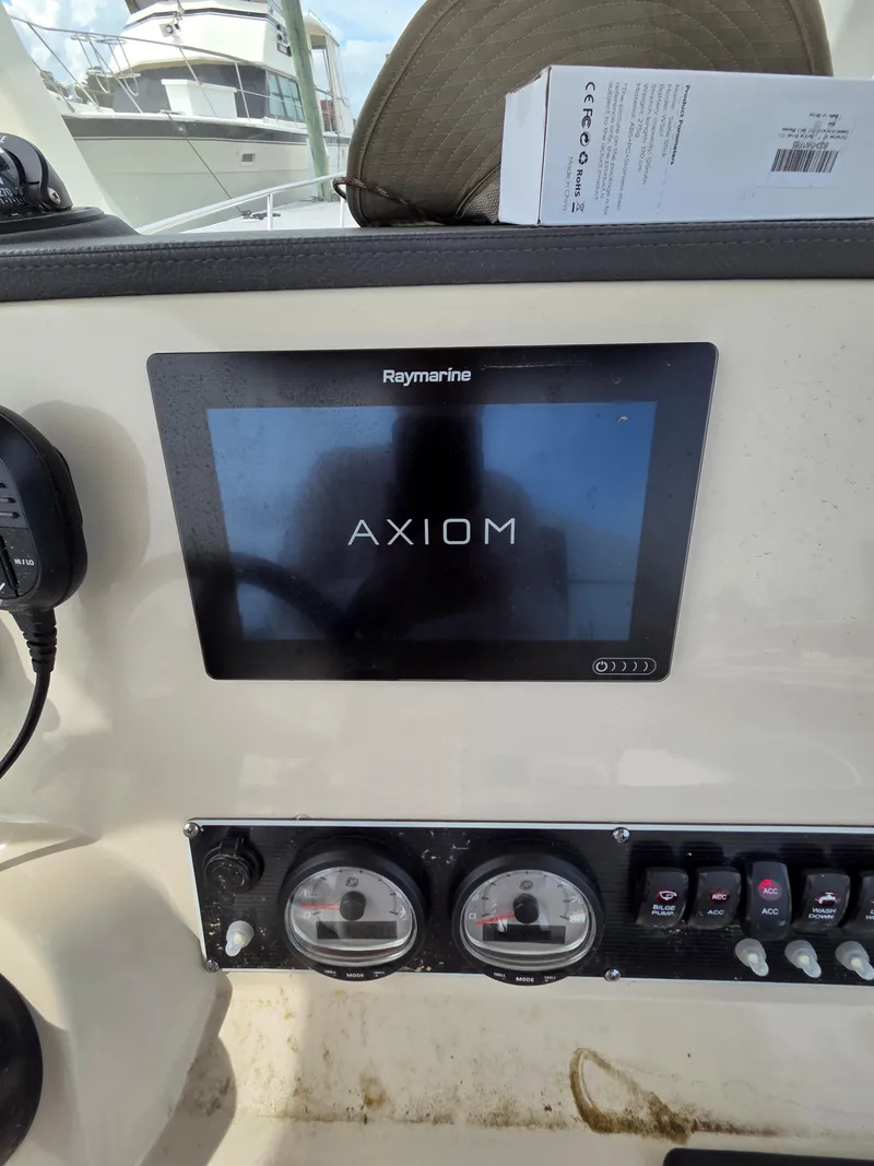 Slide: The Image of 2019 Boston Whaler 240 Dauntless dashboard with Raymarine Axiom display and controls. - 21