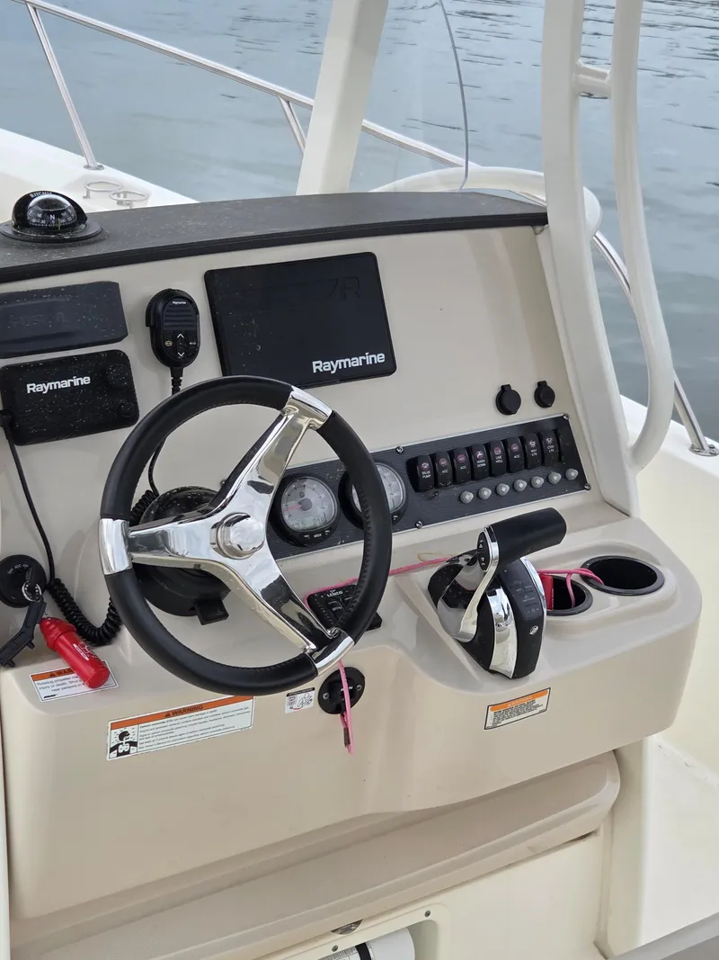 Slide: The Image of 2019 Boston Whaler 240 Dauntless helm with Raymarine electronics and steering wheel. - 3