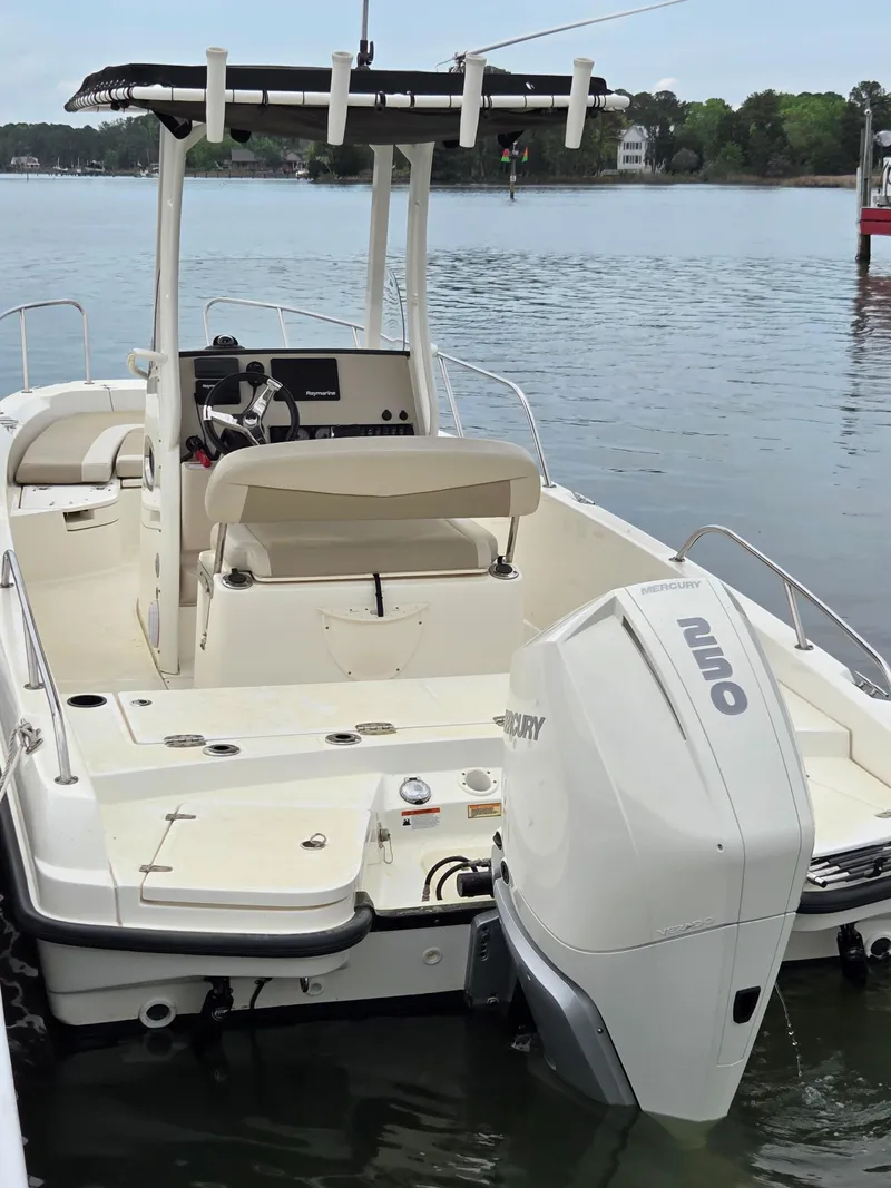 Slide: The Image of 2019 Boston Whaler 240 Dauntless boat docked on calm water. - 4