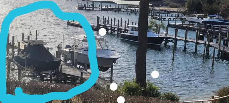 Slide: The Image of 2019 Boston Whaler 240 Dauntless docked at a scenic marina. - 7