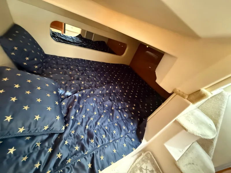 Slide: The Image of 2007 Regal 2860 Window Express cabin with star-patterned bedding and cozy interior. - 10