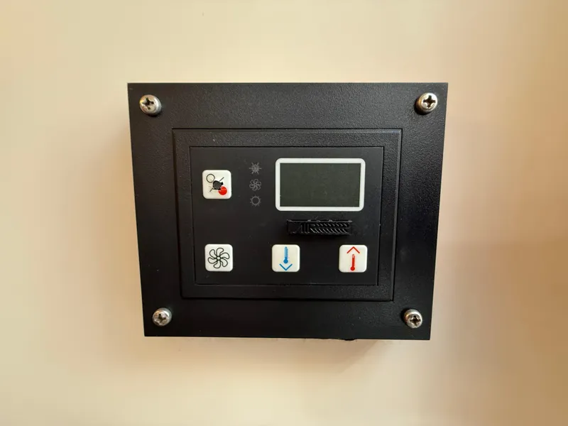 Slide: The Image of Control panel of a 2007 Regal 2860 Window Express boat, featuring temperature and fan controls. - 12