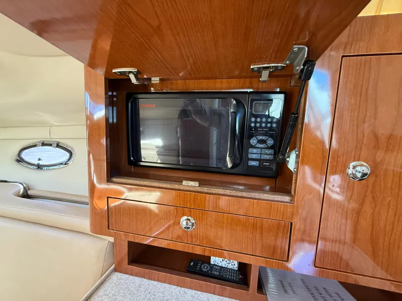Slide: The Image of 2007 Regal 2860 Window Express interior with built-in microwave and wooden cabinetry. - 15