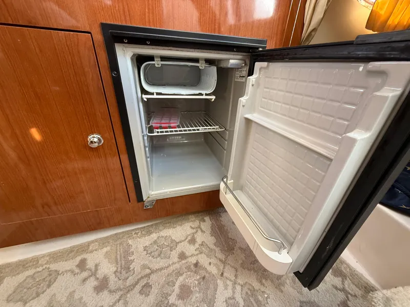 Slide: The Image of Open mini fridge inside 2007 Regal 2860 Window Express boat cabin. - 17