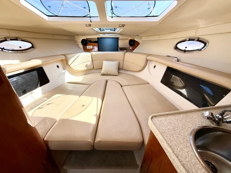 Slide: The Image of 2007 Regal 2860 Window Express cabin interior with beige seating and skylights. - 20