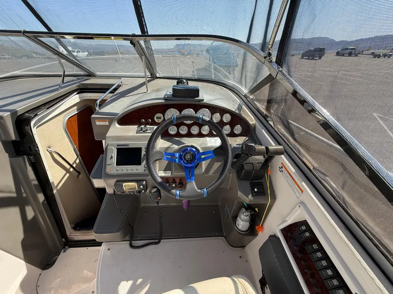 Slide: The Image of 2007 Regal 2860 Window Express boat cockpit with steering wheel and control panel. - 23