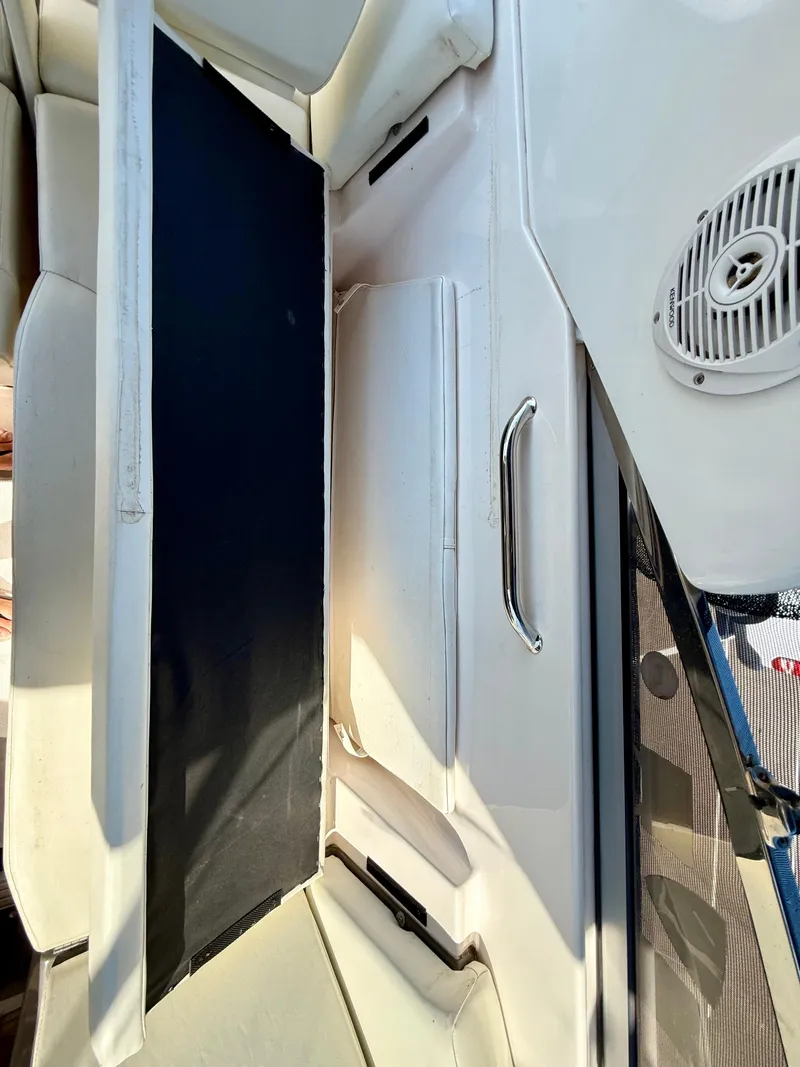 Slide: The Image of 2007 Regal 2860 Window Express boat interior with seating and speaker. - 26