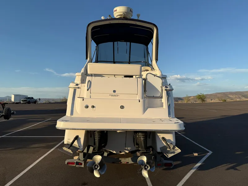 Slide: The Image of 2007 Regal 2860 Window Express boat, rear view, parked on asphalt under clear sky. - 4