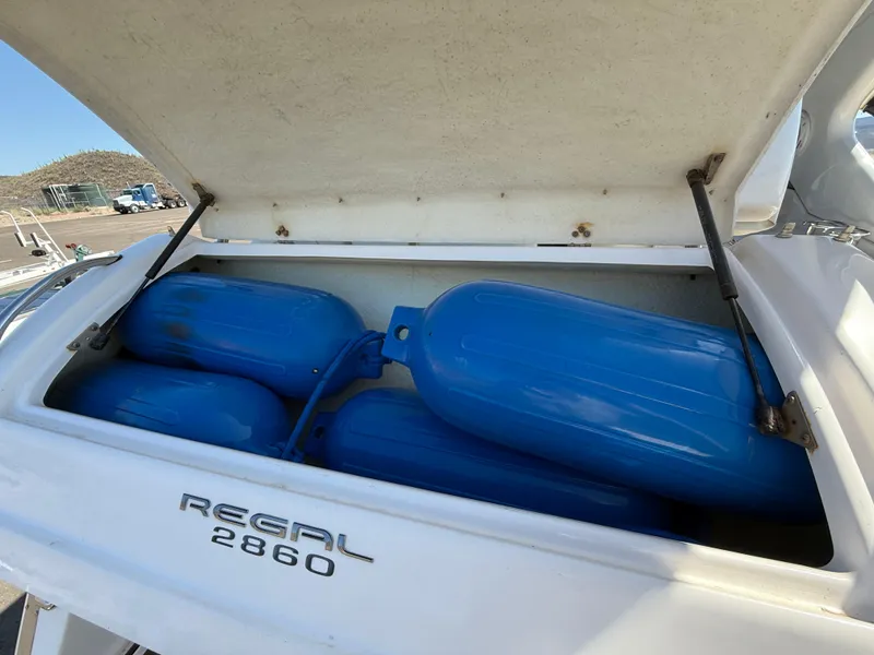 Slide: The Image of Open storage compartment on 2007 Regal 2860 boat with blue fenders inside. - 40