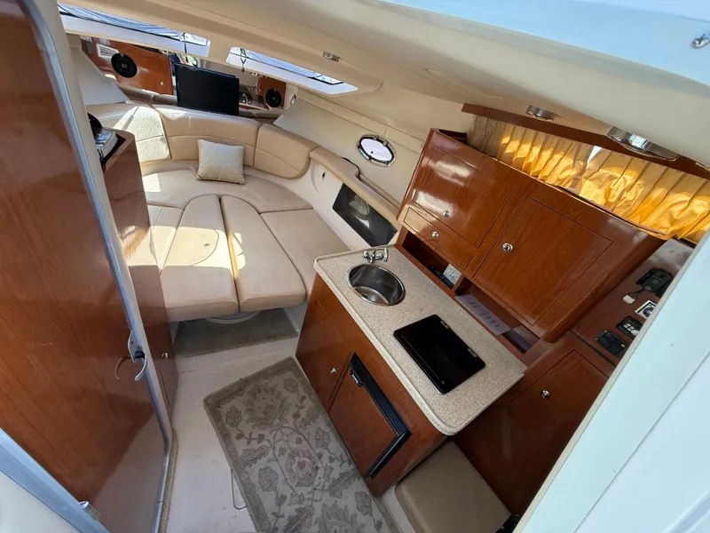 Slide: The Image of Interior of 2007 Regal 2860 Window Express boat with kitchenette and seating area. - 5