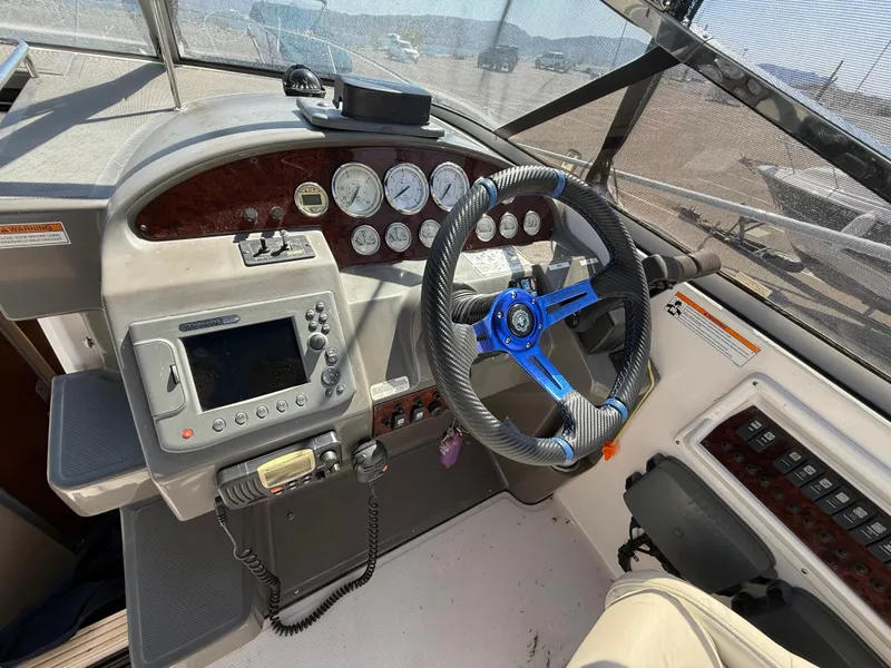 Slide: The Image of 2007 Regal 2860 Window Express boat dashboard with steering wheel and navigation controls. - 6