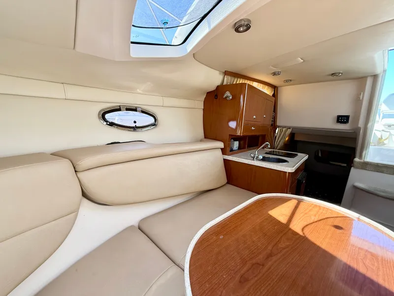 Slide: The Image of Interior of 2007 Regal 2860 Window Express boat with seating and kitchenette. - 7