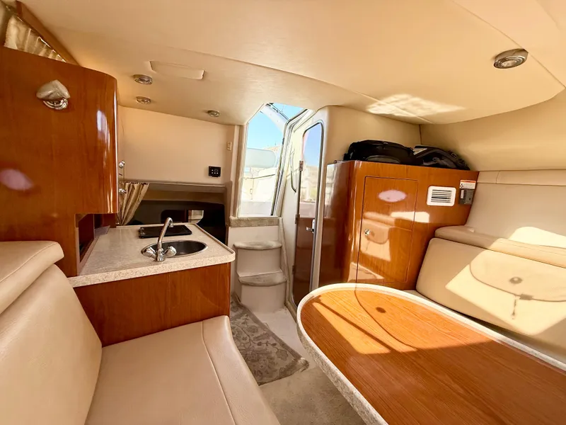 Slide: The Image of 2007 Regal 2860 Window Express cabin interior with kitchenette and seating area. - 8