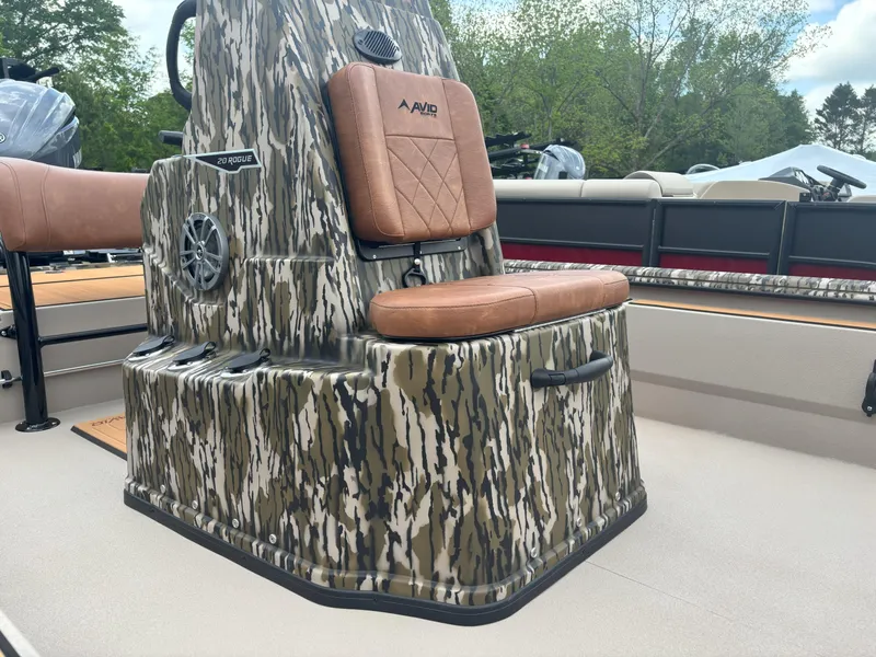 Slide: The Image of 2025 Avid 20CC Rogue boat with camo design and brown seating. - 12