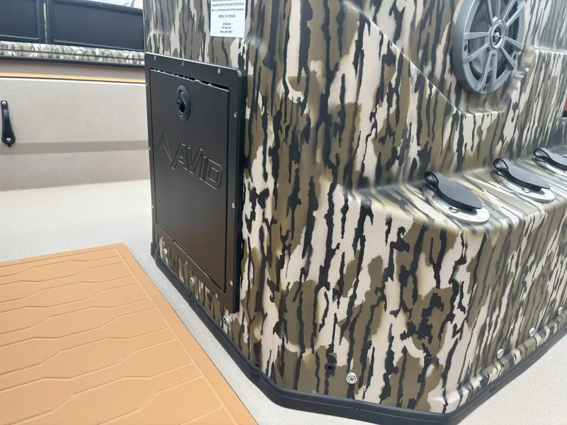Slide: The Image of 2025 Avid 20CC Rogue boat with camouflage design and speaker detail. - 14