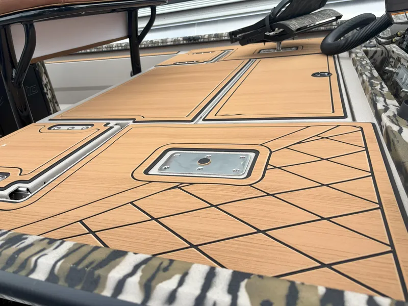 Slide: The Image of Avid 20CC Rogue 2025 boat deck with sleek wood finish and geometric patterns. - 15