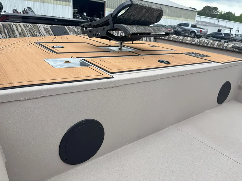 Slide: The Image of 2025 Avid 20CC Rogue boat deck with camo seat and storage compartments. - 16