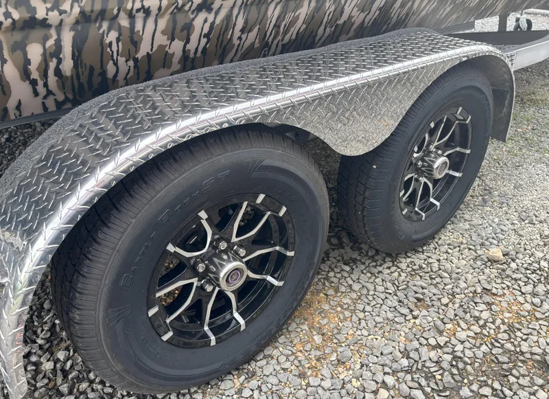 Slide: The Image of Trailer wheels of 2025 Avid 20CC Rogue on gravel surface. - 17